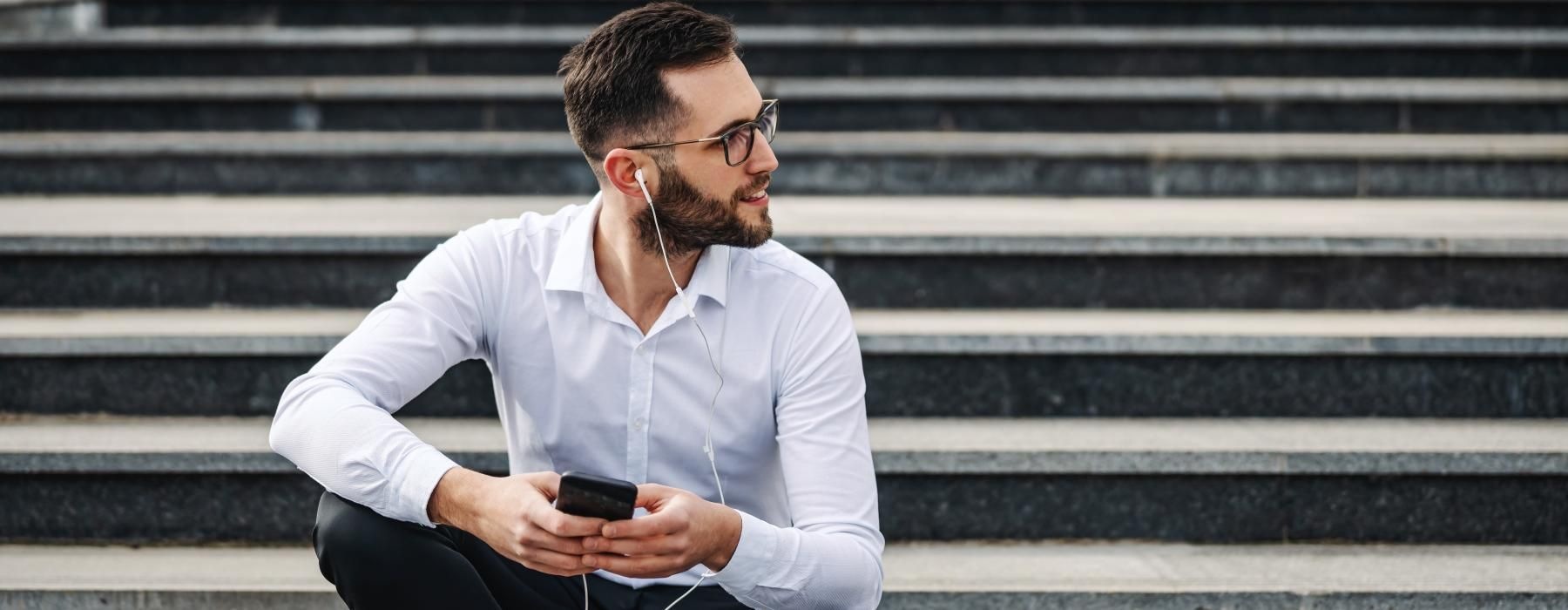 a person sitting on stairs looking at the phone