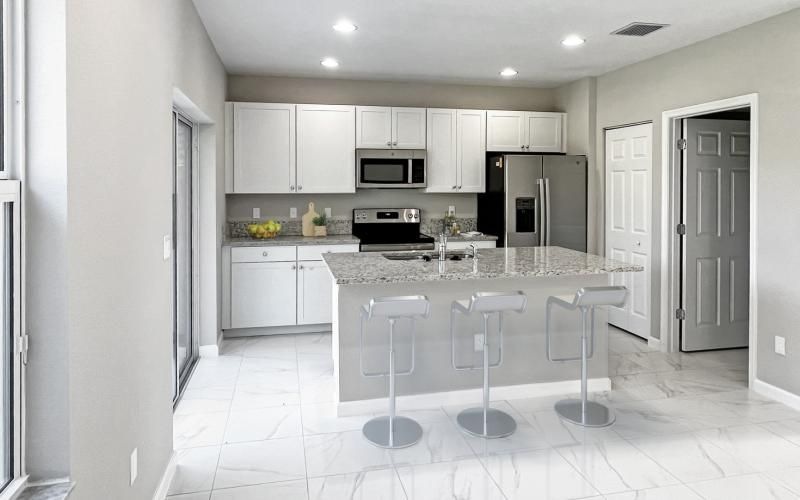a kitchen with white cabinets