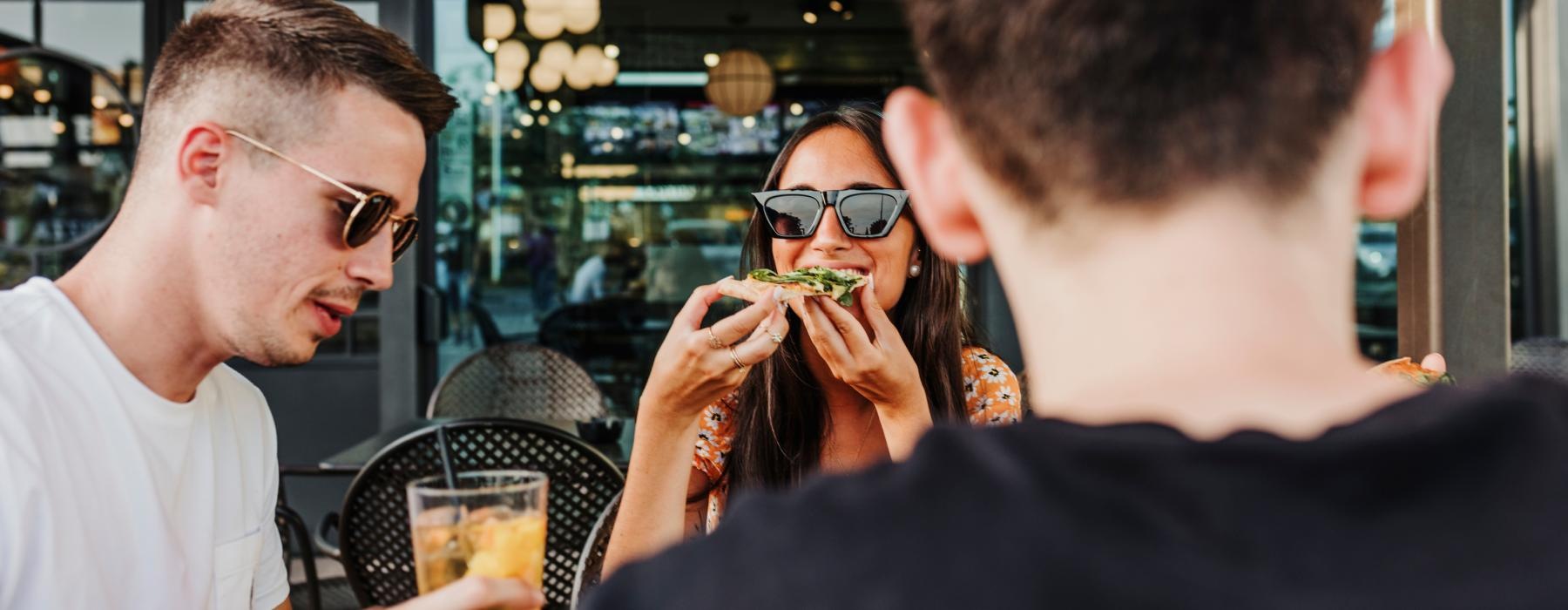 a man with glasses and a woman with a drink in his hand